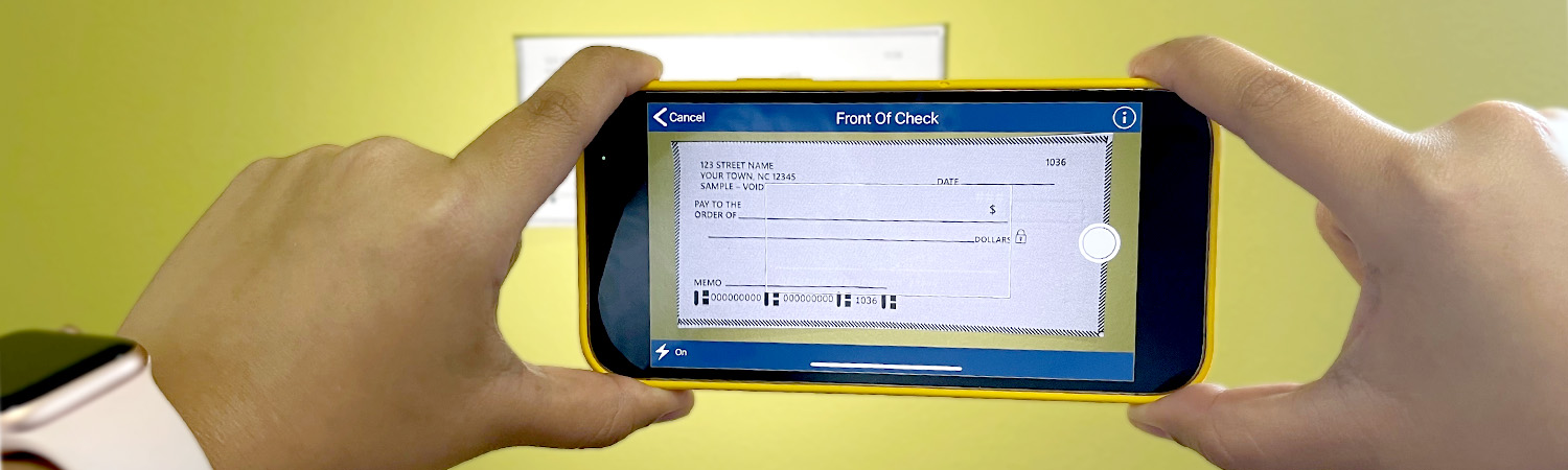 LCCU employee taking a photo of a check with the mobile app