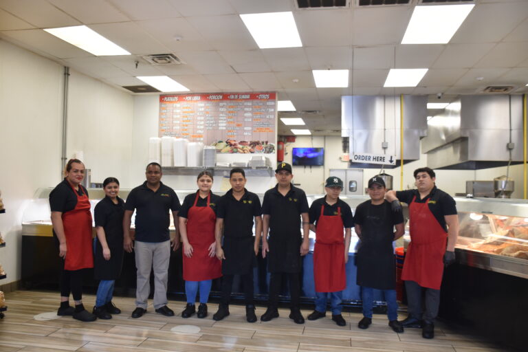 Vicente in his restaurant and staff