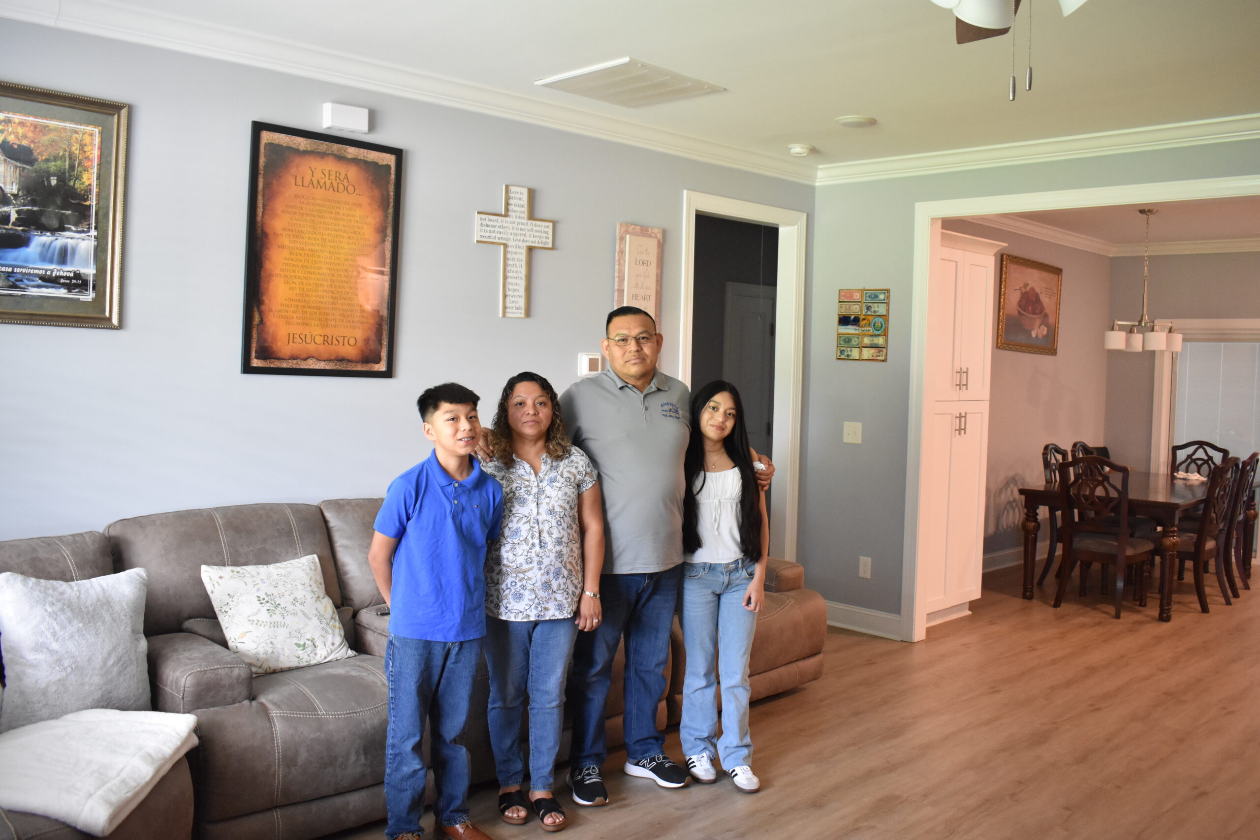 members Alvaro and family inside their home